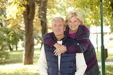 Smiling senior couple outdoor - obrazy, fototapety, plakaty
