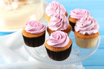 Tasty cupcake on color wooden background