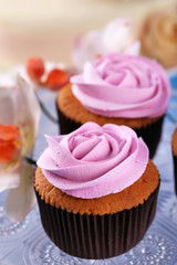 Tasty cupcakes on color wooden background