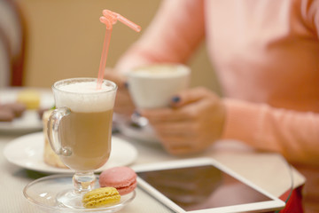 Woman holding cup of coffee in cafe