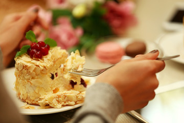 Woman eating cake in cafe
