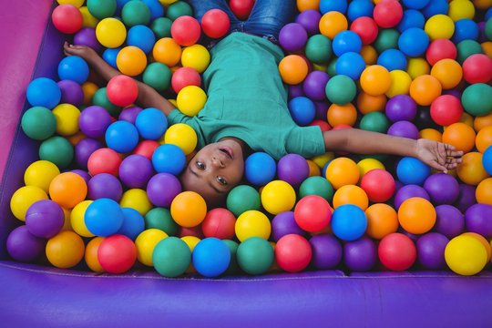 Cute smiling boy in sponge ball pool