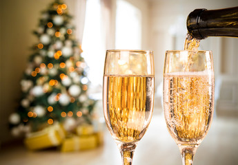Two Champagne Glass On Defocused Background Living Room With Christmas Tree