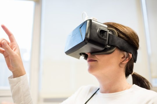 Businesswoman using oculus rift headset