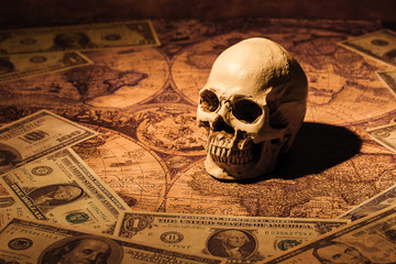 Capitalism concept : Skull on bank note and vintage map backgrou