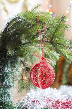 Christmas crochet woven ball in tree on colorful background bokeh among Christmas and New Year decor