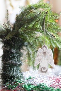 Christmas angel in tree on colorful background bokeh among Christmas and New Year decor