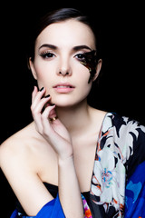 Portrait of pretty woman face with false feather eyelashes fashion makeup