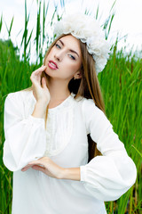 Fototapeta na wymiar Beautiful sexy woman face wearing floral white wreath outdoors