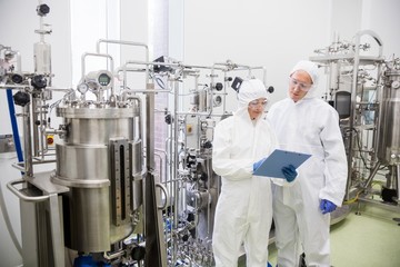 Scientists working with large vat