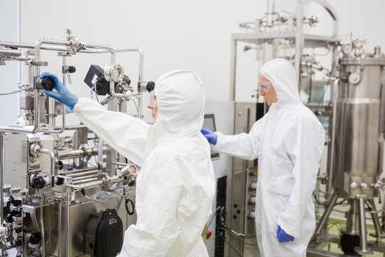 Scientists working with large vat