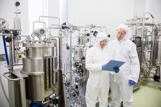 Scientists working with large vat