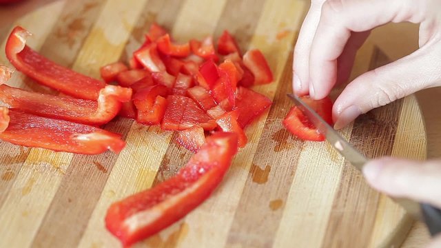 Cutting red pepper with knife