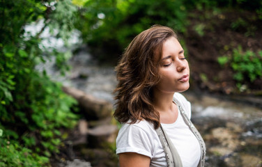 Fototapeta premium Calm portrait of a girl near the river