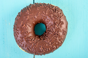 Chocolate Donut With Sparkles On Blue Background