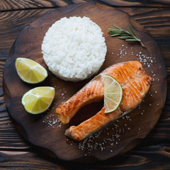 Above view of fried trout steak served with rice, close-up