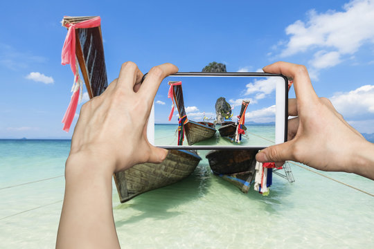 Girl taking pictures on mobile smart phone in poda island karbi,