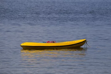 Foto op Canvas Light rubber boat without a motor, calm Sea   © Tazzjang