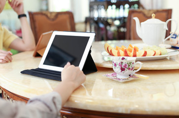 Business people having lunch and work with ipad tea and fresh fr