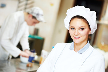 Female chef portrait decorating fish plate