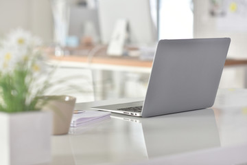 Laptop computer set on table in office