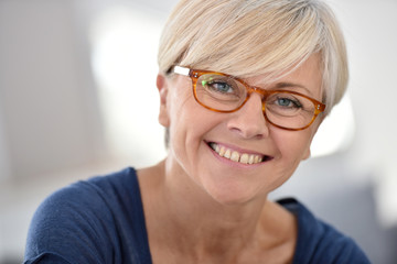 Fototapeta na wymiar Portrait of smiling senior woman with eyeglasses