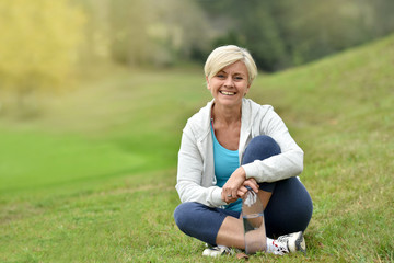 Fototapeta premium Senior woman relaxing outside, sit in park