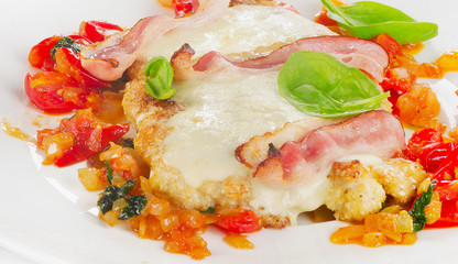 Chicken breast fillet baked with cheese, bacon and tomatoes.