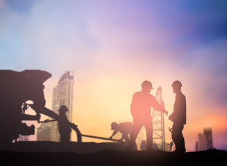 silhouette engineer working  in a building site over Blurred con