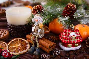 Xmas or new year composition with holiday decoration - Homemade X-mas cupcakes, sliced dried oranges on wooden background with spruce twigs. Little man figures. Christmas card