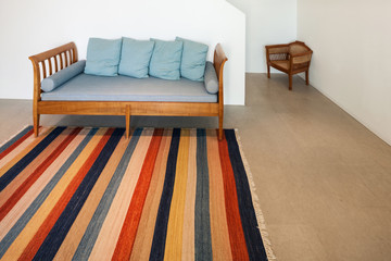 hall with divan and striped rug