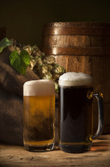 Beer barrel with beer glass on table on wooden background