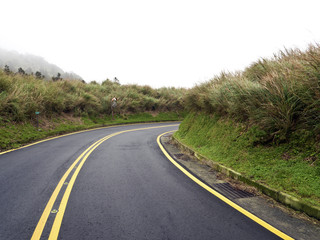 Road in mountain range in fog,Taipei