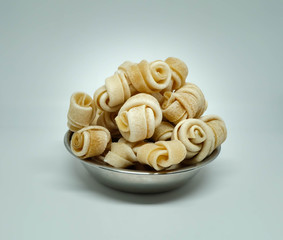 Bone snack for dogs in a silver plate