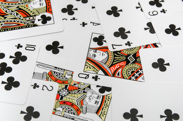 playing cards of the suit clubs as background