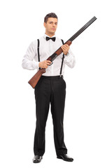 Armed young man holding a shotgun rifle