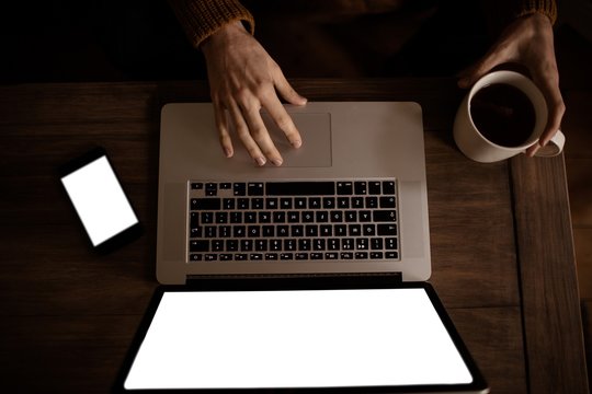 Handsome hipster using laptop in living room