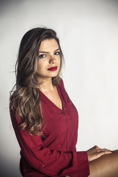 Young attractive posh girl sitting on a chair 