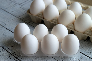 Eggs. Eggs in a plastic container and cardboard box.