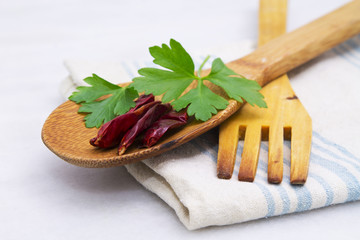 Wooden spoon and fork with parsley