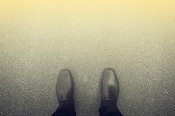 Black shoes standing on the floor and light in the front