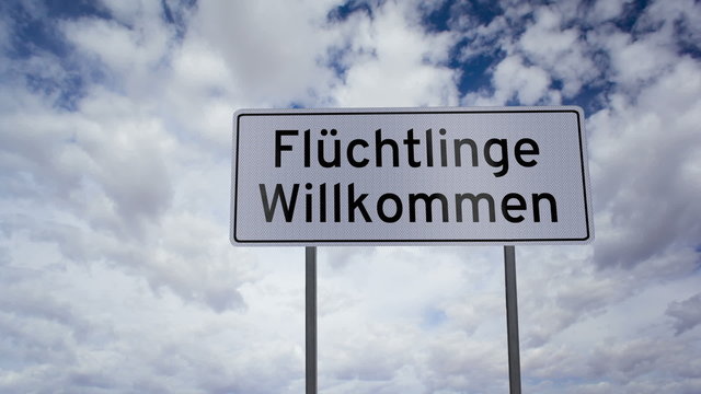 Highway road sign with the words refugees welcome written on it in the German language with a time-lapse clouds background.