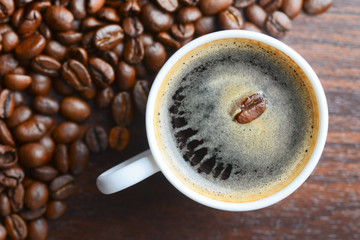 coffee grains in a white mug on a table