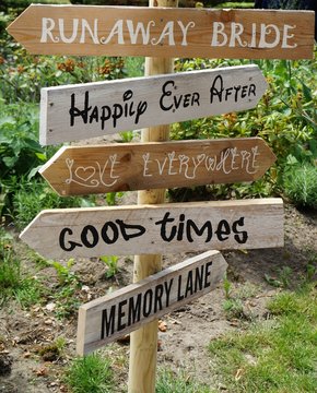 Arrows with funny texts are pointing the direction at a wedding