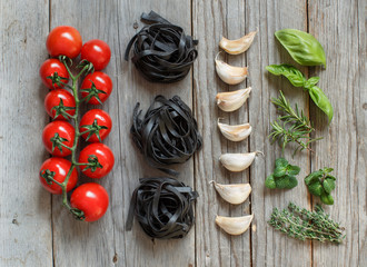Black Tagliatelle pasta with cherry tomatoes, garlic and herbs