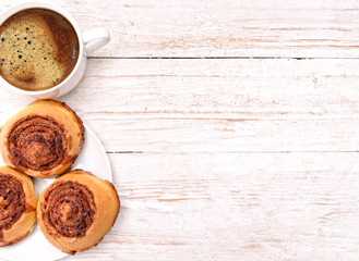 Fototapeta na wymiar Cinnamon rolls with coffee. Background.