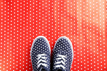 Female gumshoes on a red background