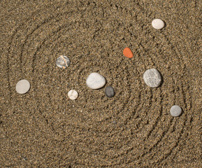 Spherical circles and stone in a shape of solar system on a natu