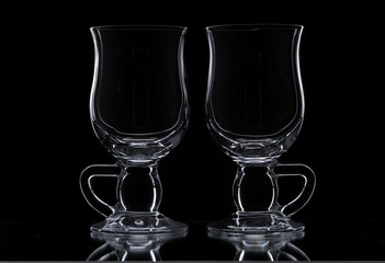 Two glasses on a black background