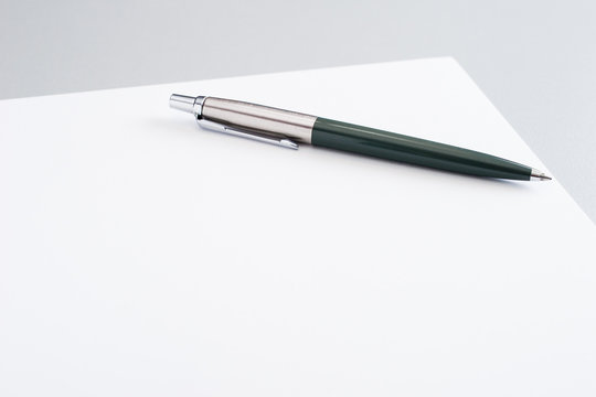 Blank sheet of paper with pen (shallow depth of field)